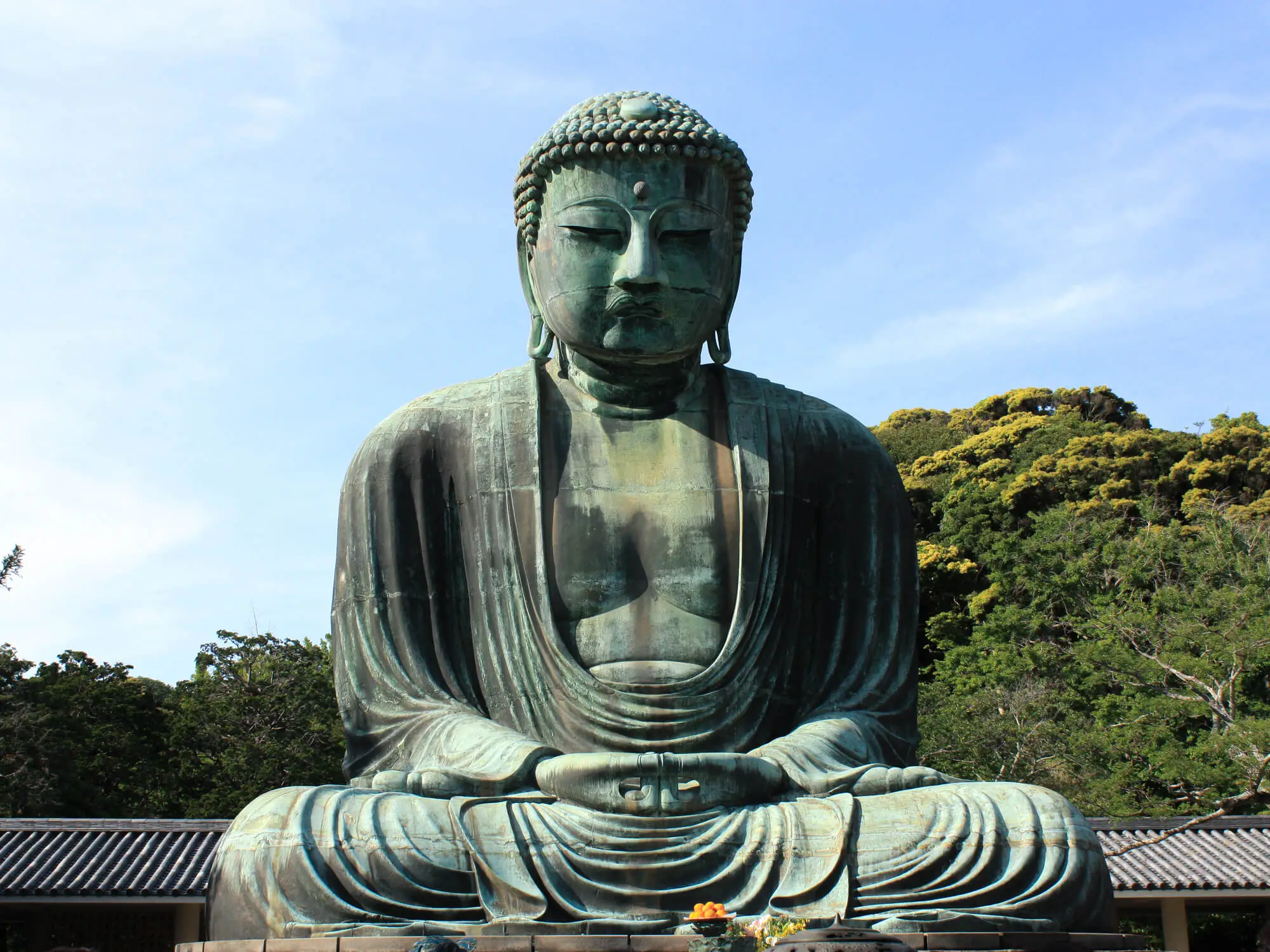 Close-up view of the towering bronze Great Buddha statue at Kotoku-in temple in Kamakura