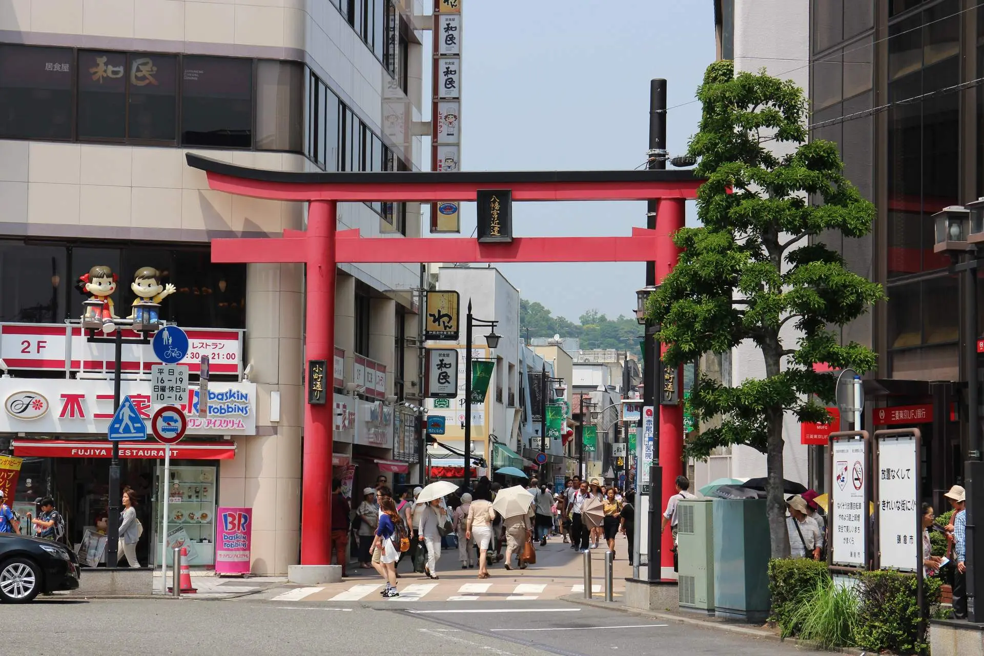 Bustling pedestrian shopping street lined with local snack stalls on Komachi-dori in Kamakura