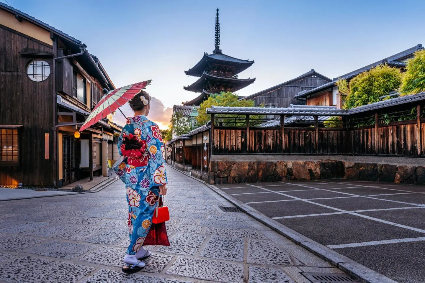 A path of vibrant red torii gates at Fushimi Inari shrine during a guided Kyoto and Osaka tour