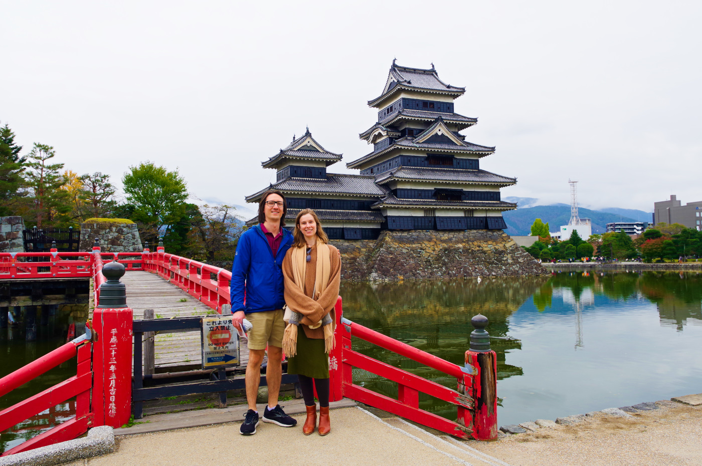 The black wooden exterior of Matsumoto Crow Castle against the backdrop of the Japan Alps