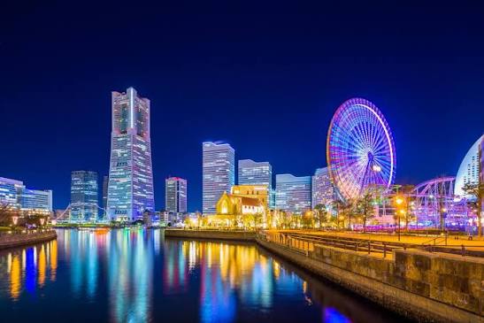 Sleek modern skyscrapers and glass towers stretching along the redeveloped futuristic harbor front