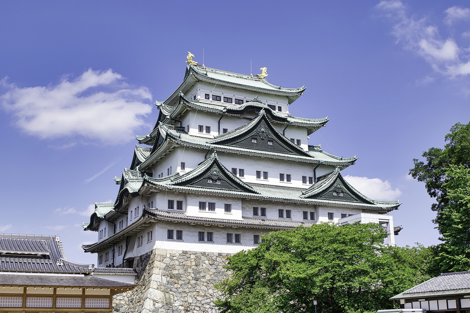 Nagoya Castle with its golden shachihoko roof ornaments beside the reconstructed Honmaru Palace