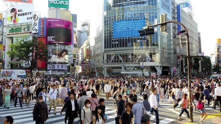 Pedestrians crossing at Shibuya's famous scramble crossing at street level