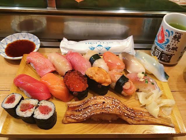 Terry guiding travelers through a bustling local seafood market on a private food tour in Tokyo
