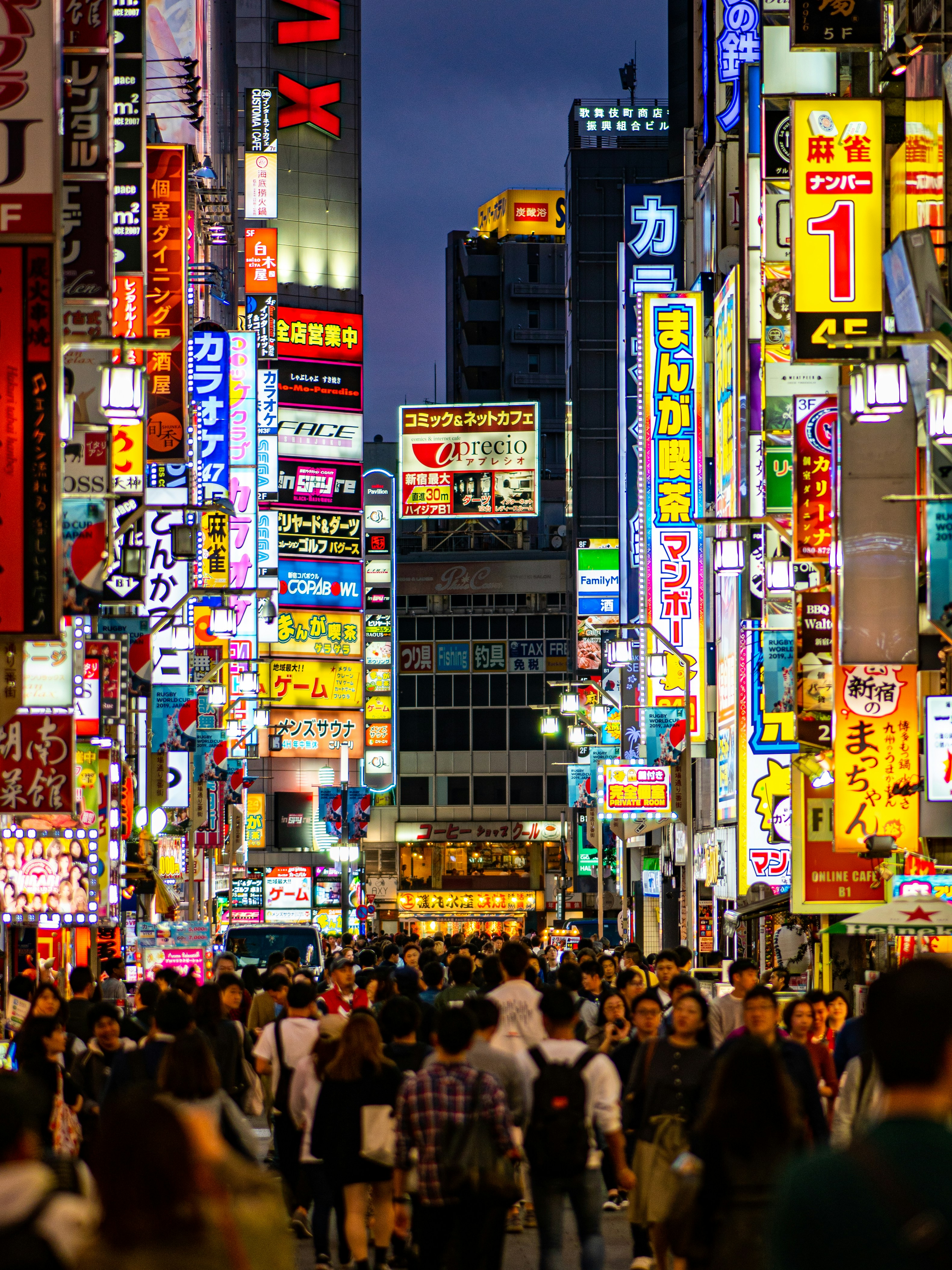 Vibrant neon lights and towering skyscrapers at dusk in the bustling Shinjuku district of Tokyo