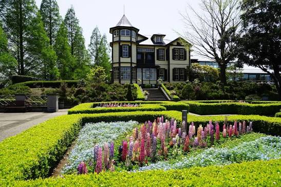 Historic Western style wooden colonial house and manicured European gardens