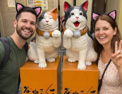 A resident cat lounging along a quiet Yanaka backstreet