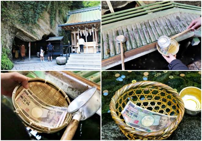 Travelers bowing and rinsing coins with wooden ladles in small wicker baskets inside the mystical candle-lit spring cave at Zeniarai Benzaiten shrine
